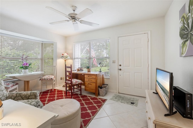 home office featuring light tile patterned floors and ceiling fan