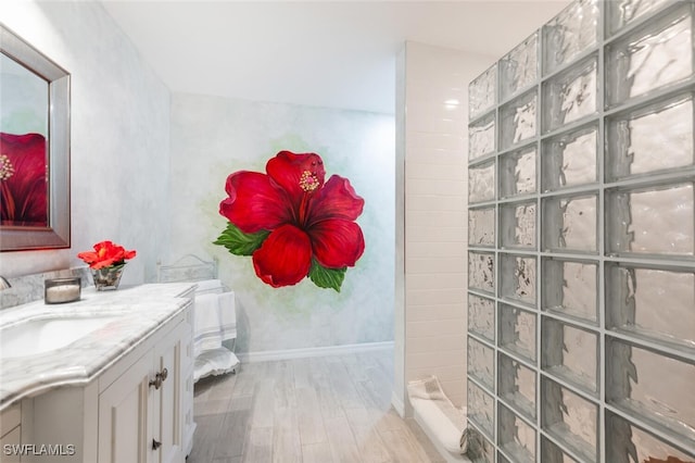 bathroom with vanity, a shower, and wood-type flooring