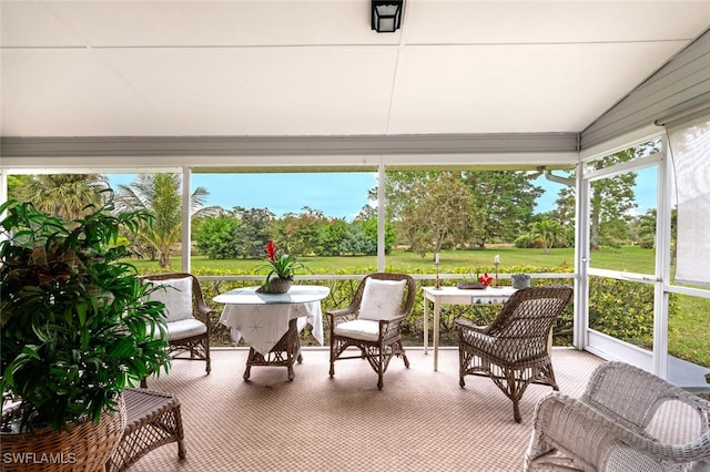 sunroom featuring a healthy amount of sunlight and lofted ceiling