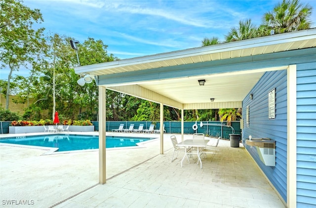 1311 Monarch Cir, Naples, FL 34116 - community pool featuring a patio and outdoor dining space