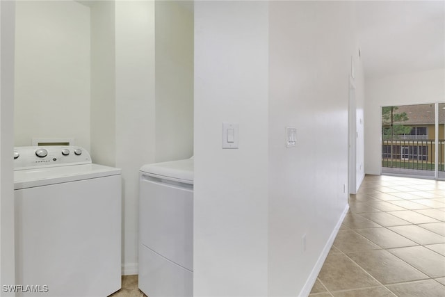 laundry room featuring light tile patterned floors and washing machine and dryer