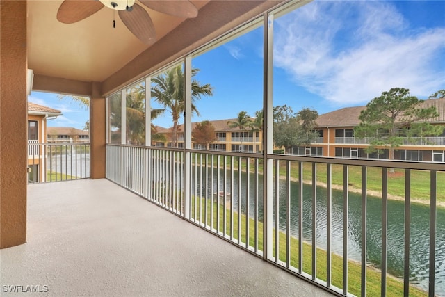 balcony with a water view and ceiling fan