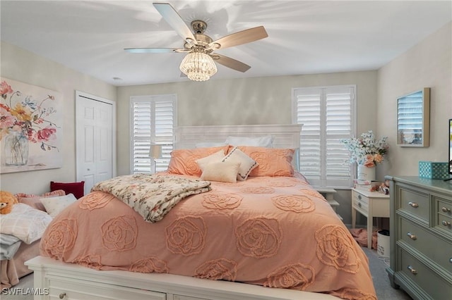 bedroom with ceiling fan and a closet