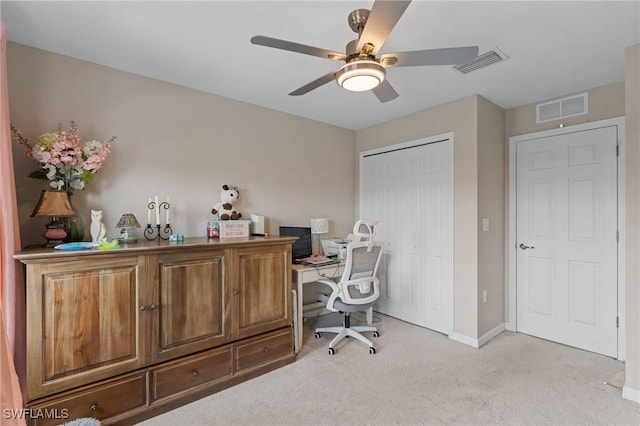 carpeted office featuring ceiling fan