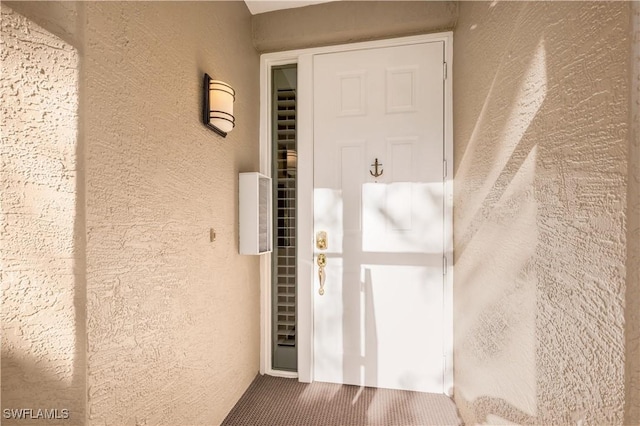 property entrance featuring stucco siding