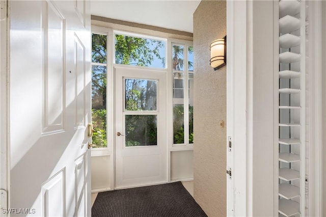 doorway to outside featuring a textured wall