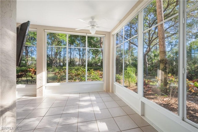 unfurnished sunroom with a ceiling fan