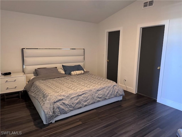 bedroom with dark hardwood / wood-style floors and vaulted ceiling