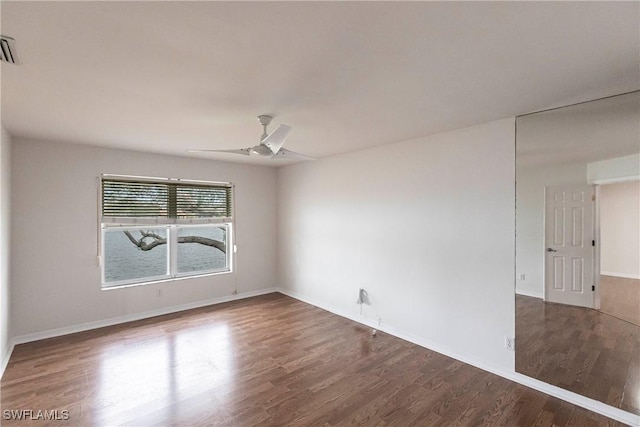 empty room with ceiling fan and wood-type flooring