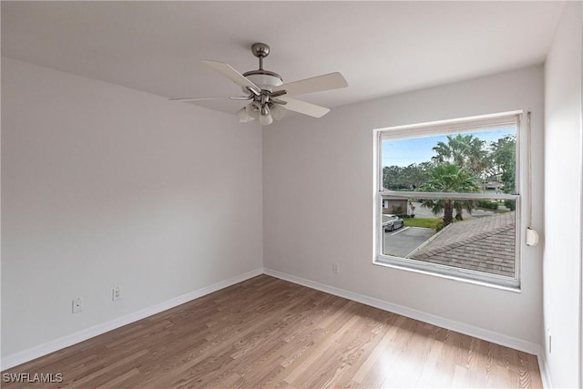 empty room with ceiling fan and wood-type flooring