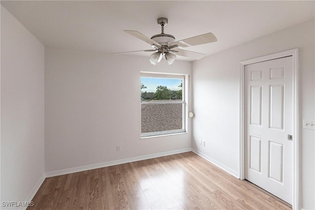 empty room featuring light wood-type flooring and ceiling fan