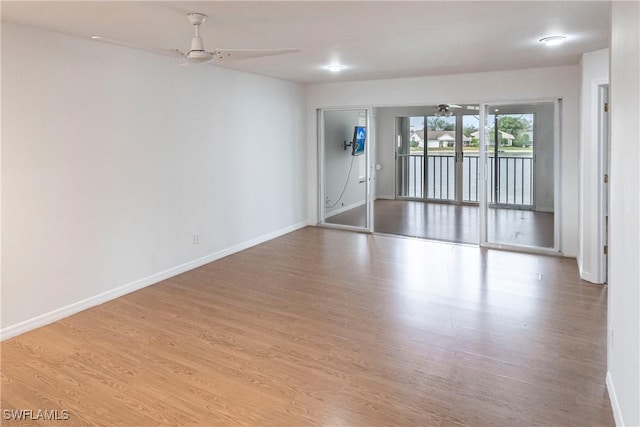 empty room with ceiling fan and light wood-type flooring