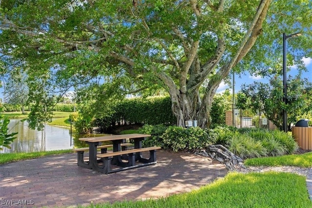 view of property's community with a patio area and a water view