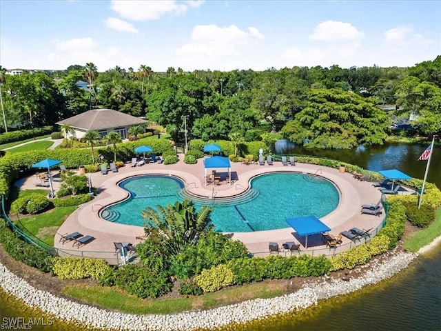 view of pool featuring a patio area and a water view