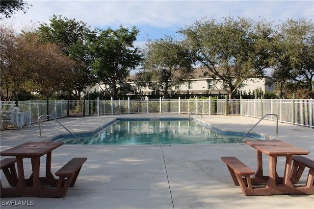 pool featuring a patio area and fence