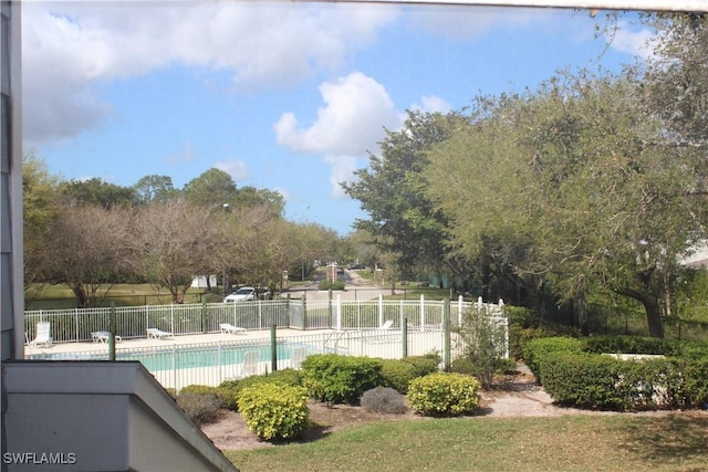 pool with a patio area and fence