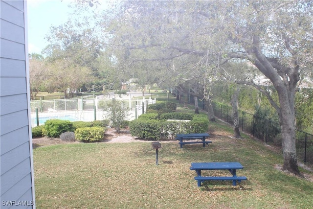 view of yard with fence and a community pool