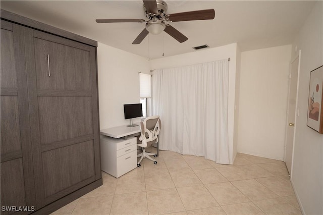 tiled office space with ceiling fan