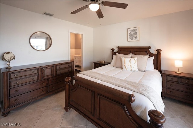 tiled bedroom featuring ensuite bathroom and ceiling fan