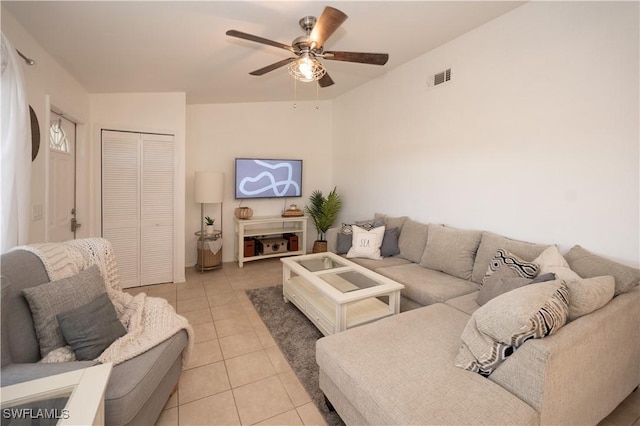 tiled living room featuring ceiling fan