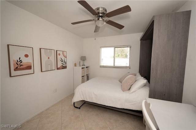 tiled bedroom featuring ceiling fan