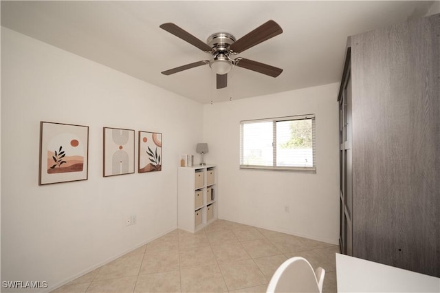 tiled empty room with ceiling fan