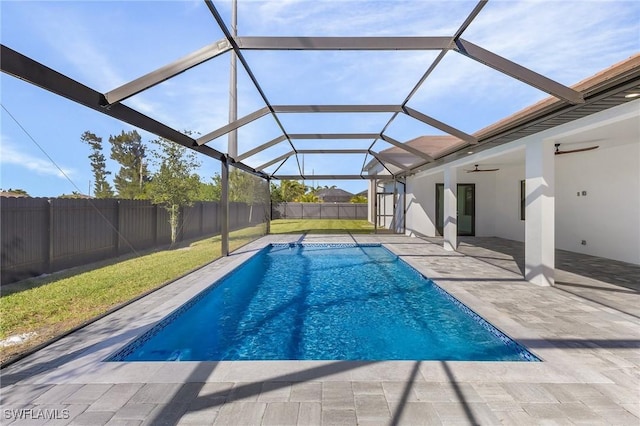 view of swimming pool featuring a lanai, ceiling fan, and a patio