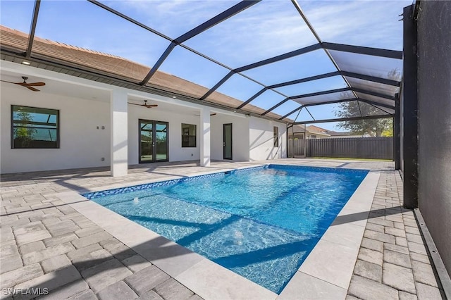 view of swimming pool featuring ceiling fan, a patio area, and a lanai