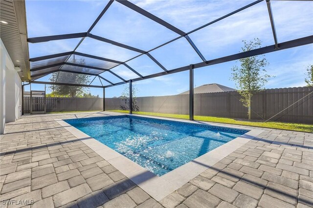 view of pool featuring a lanai and a patio