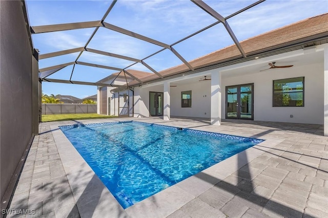 view of pool with a lanai, ceiling fan, and a patio area