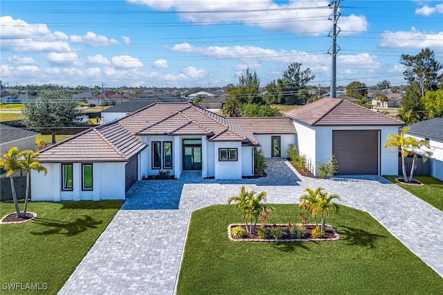 view of front of home with a front lawn and a garage