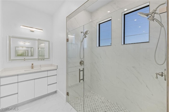 bathroom with walk in shower and vanity