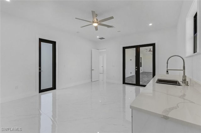 interior space with ceiling fan, french doors, and sink