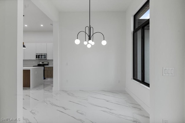 unfurnished dining area featuring a notable chandelier