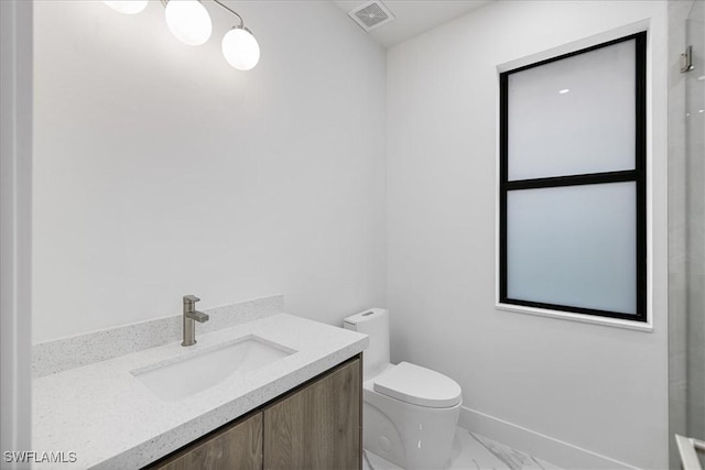 bathroom featuring toilet and vanity