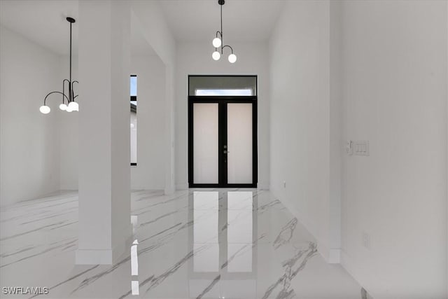 entryway with an inviting chandelier and french doors