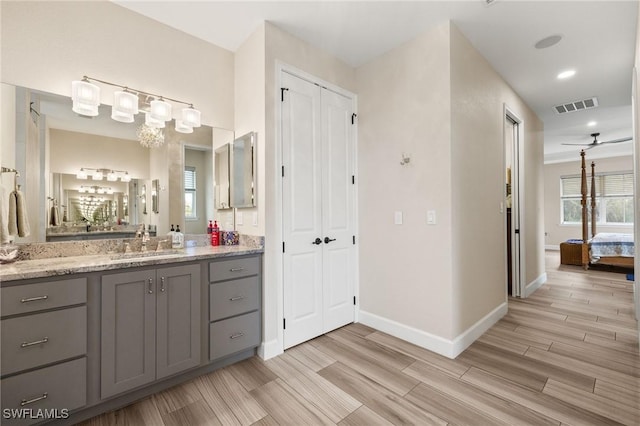 full bath with wood tiled floor, visible vents, a closet, and vanity