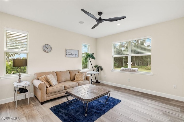 living room featuring plenty of natural light, light wood finished floors, and baseboards