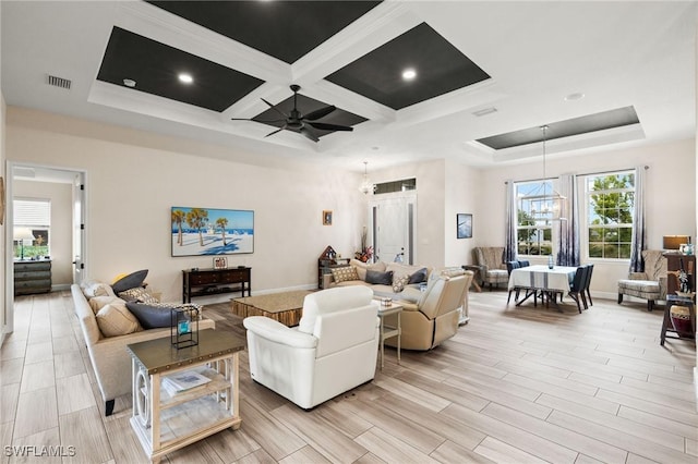 living room with beamed ceiling, ceiling fan with notable chandelier, coffered ceiling, and ornamental molding