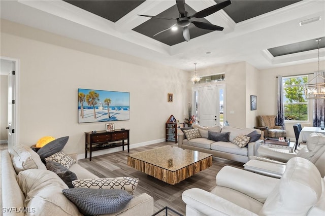 living area with visible vents, wood finished floors, coffered ceiling, baseboards, and ceiling fan with notable chandelier