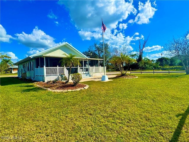 exterior space with a sunroom and a lawn