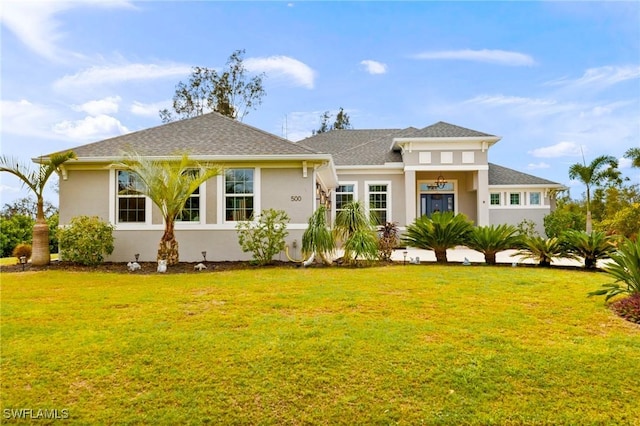 view of front of house featuring a front yard and stucco siding