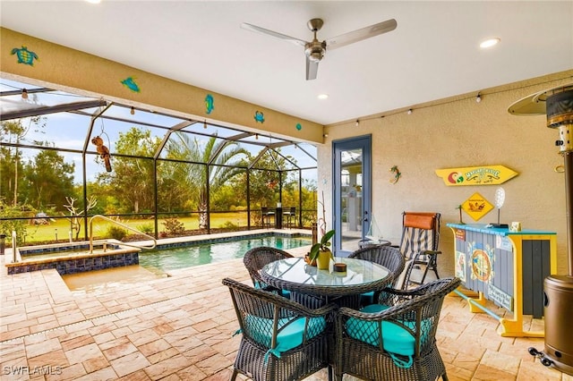 view of patio / terrace with a pool with connected hot tub, a lanai, and ceiling fan