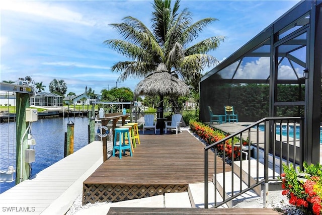 dock area with glass enclosure and a water view