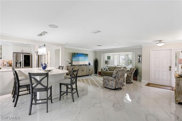 dining space with ornamental molding