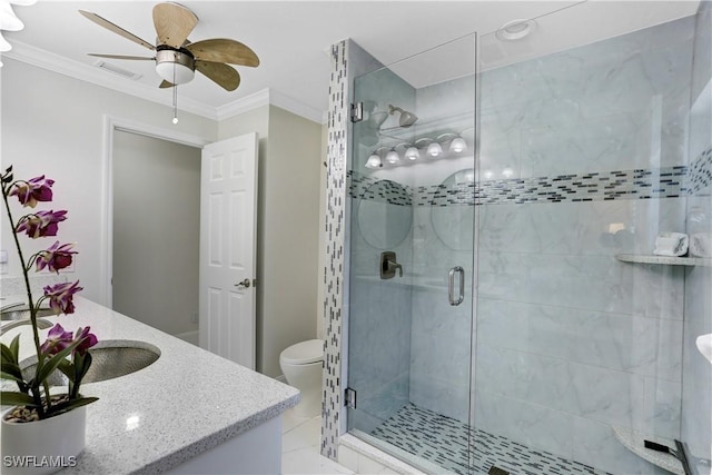 bathroom with toilet, vanity, ornamental molding, and an enclosed shower