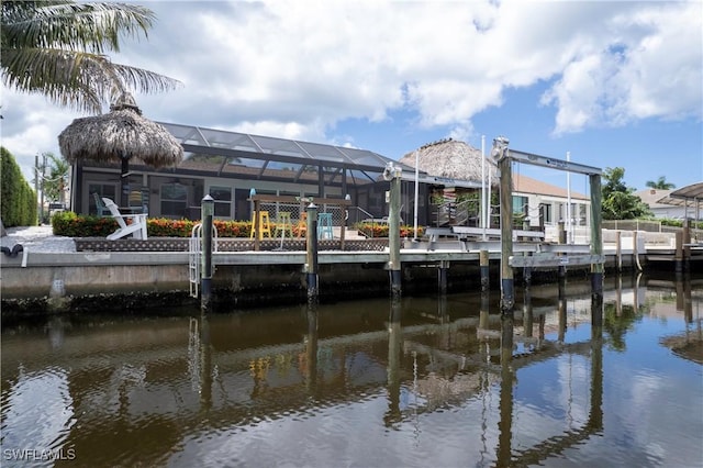 view of dock featuring a lanai and a water view