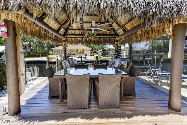 dock area with a gazebo and a deck with water view