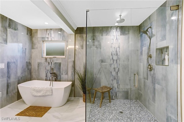 bathroom featuring plus walk in shower and tile walls