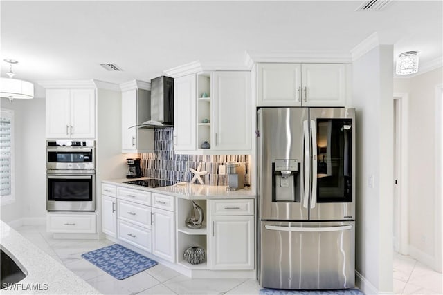 kitchen with wall chimney range hood, decorative backsplash, appliances with stainless steel finishes, ornamental molding, and white cabinets